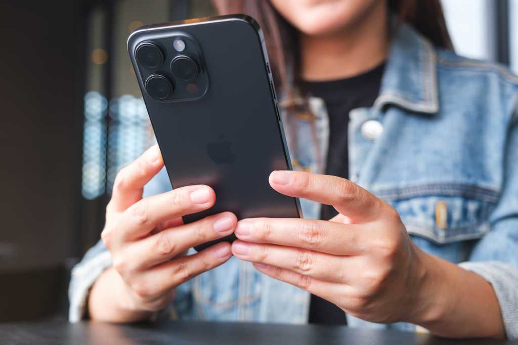 Aug,5th,2024,:,A,Woman,Holding,And,Using,Iphone